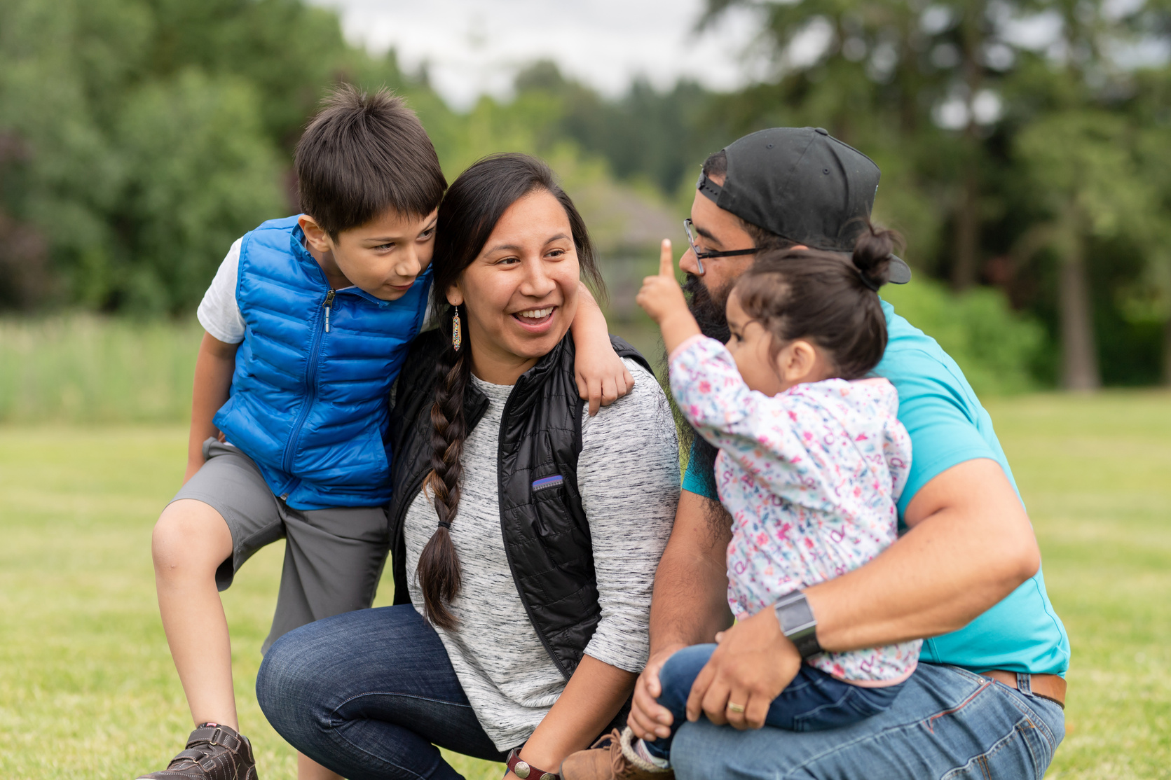 Native American family playing together on a soccer field